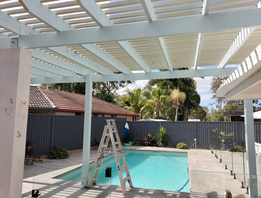 White pergola over a backyard pool, a Seaforth Builders project on the Gold Coast