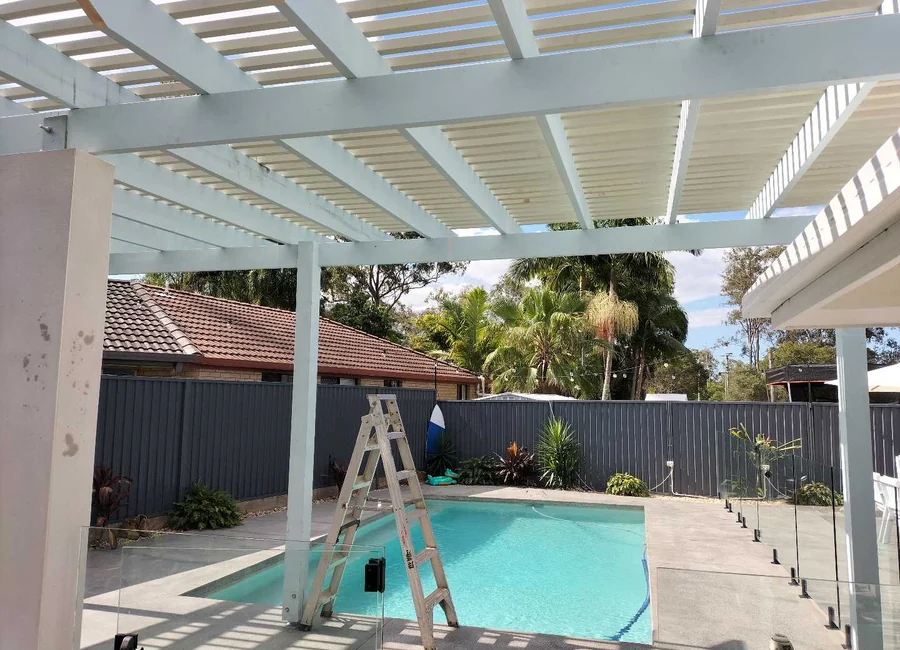White pergola over a backyard pool, a Seaforth Builders project on the Gold Coast